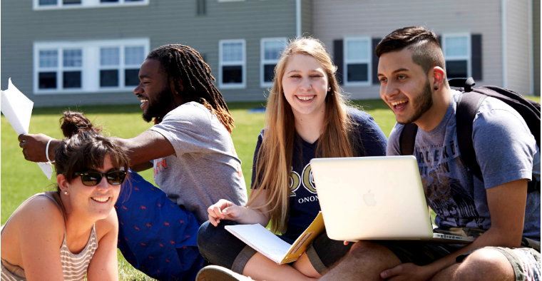 Students studying in front of resident hall