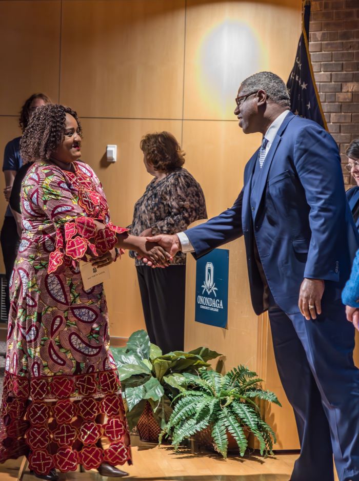 Nursing student Lieve Marie-Claire Kitsa (left) is welcomed into the Phi Theta Kappa Honor Society by OCC President Dr. Warren Hilton (right).